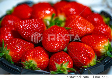 Fresh organic strawberries background, Fresh ripe organic strawberry in a dark plate Fresh organic strawberries background, Fresh ripe organic strawberry in a dark plate 140815380
