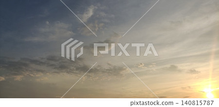 A beautiful sunset sky and vast cloud landscape bathed in the light of the setting sun - background image A beautiful sunset sky and vast cloud landscape bathed in the light of the setting sun - background image 140815787