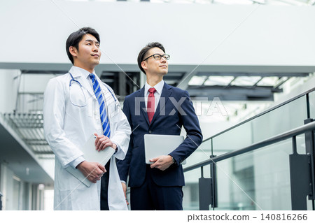 Doctors and businessmen in white coats meeting at hospital Doctors and businessmen in white coats meeting at hospital 140816266