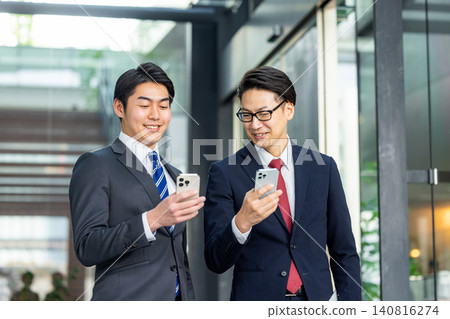 Businessman looking at a smartphone Businessman looking at a smartphone 140816274