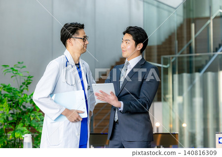 Doctors in white coats having a meeting at the hospital Doctors in white coats having a meeting at the hospital 140816309