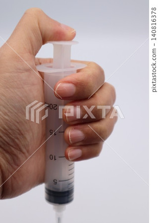 Person holding a syringe Person holding a syringe 140816378