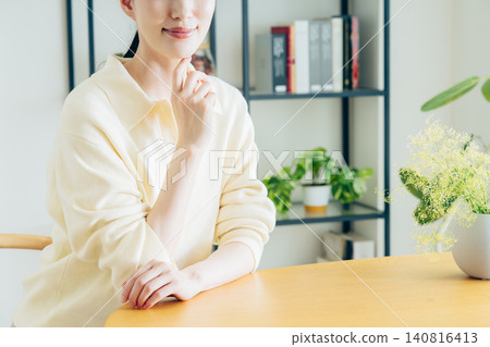一個年輕的女人在家中休息 一個年輕的女人在家中休息 140816413