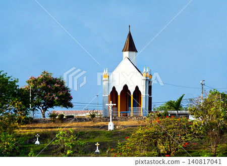 The historic Chapelle du Calvaire stands on a grassy hill under a clear blue sky in Fort-de-France, Martinique. The historic Chapelle du Calvaire stands on a grassy hill under a clear blue sky in Fort-de-France, Martinique. 140817041