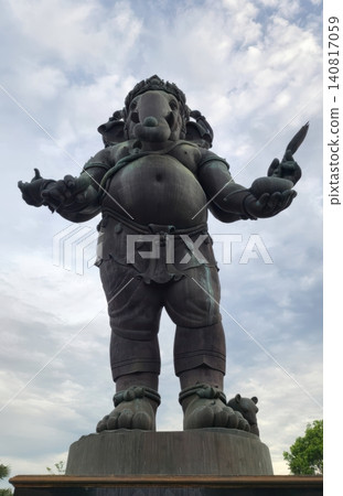 Majestic Standing Bronze Ganesha Statue Against a Cloudy Sky Majestic Standing Bronze Ganesha Statue Against a Cloudy Sky 140817059
