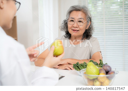Asian woman nutritionist doctor discussing medical treatment with senior patient, dietitian advice. Asian woman nutritionist doctor discussing medical treatment with senior patient, dietitian advice. 140817547