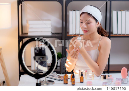 Young asian woman presenting and review cosmetic product with on social media. Young asian woman presenting and review cosmetic product with on social media. 140817590