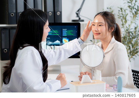 Doctor touching face of patient in clinic and discussing skin analysis on computer screen with ai. 140817605