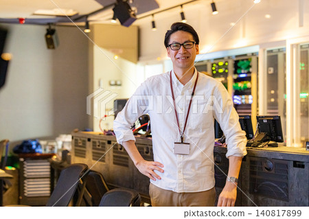 A director working in a broadcasting station's control room A director working in a broadcasting station's control room 140817899