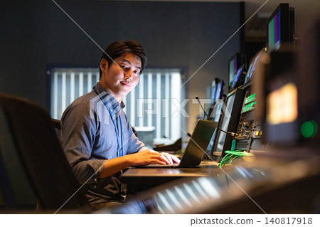 Staff working in a broadcasting station's control room Staff working in a broadcasting station's control room 140817918