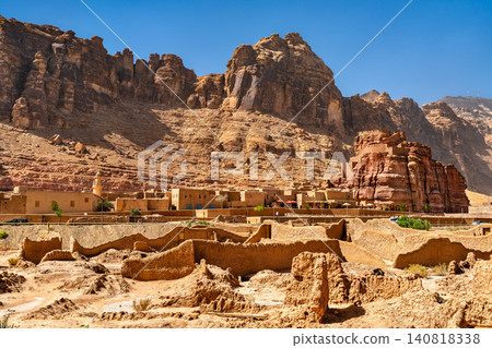 Panoramic view of the historic mud brick ruins and heritage buildings of AlUla Old Town nestled against sandstone mountains in Saudi Arabia. Panoramic view of the historic mud brick ruins and heritage buildings of AlUla Old Town nestled against sandstone mountains in Saudi Arabia. 140818338