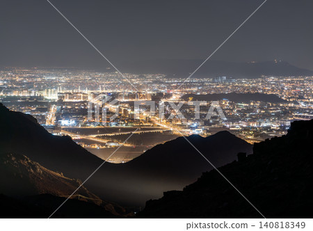 A wide panoramic view of the illuminated city of Madinah at night seen from the Jabal Uhud viewpoint in Saudi Arabia 140818349
