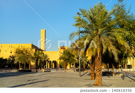 View of the traditional Imam Turki bin Abdullah Grand Mosque and palm trees in the historic Ad Dirah district of Riyadh, Saudi Arabia. View of the traditional Imam Turki bin Abdullah Grand Mosque and palm trees in the historic Ad Dirah district of Riyadh, Saudi Arabia. 140818356