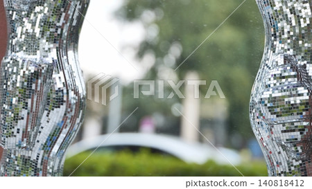 Sculptural elements reflecting light in a park environment Sculptural elements reflecting light in a park environment 140818412