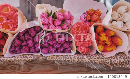 Colorful spring tulip bouquets wrapped in paper for sale at a flower market Colorful spring tulip bouquets wrapped in paper for sale at a flower market 140818449