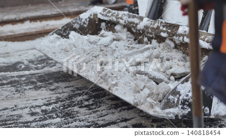 Utility vehicle clearing snow and ice on urban area street in winter Utility vehicle clearing snow and ice on urban area street in winter 140818454