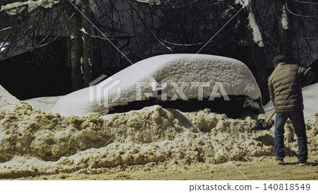 Person shoveling heavy snow from car during severe winter storm nightmare at night 140818549