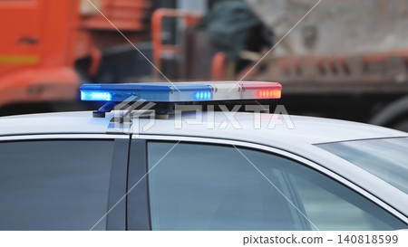 Police patrol vehicle with flashing blue and red emergency lights on city street Police patrol vehicle with flashing blue and red emergency lights on city street 140818599