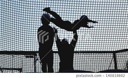 People taking indoor skydiving lessons experiencing freefall in a wind tunnel People taking indoor skydiving lessons experiencing freefall in a wind tunnel 140818602