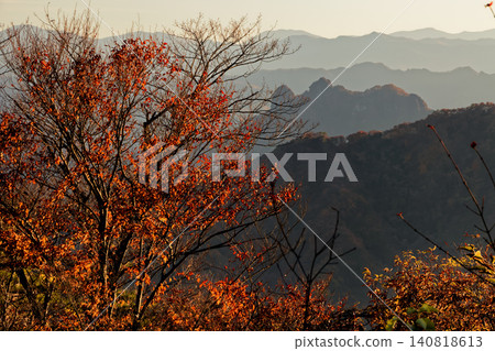 Mount Shikadake at sunset, as seen from the observation deck of Mount Myogi. Mount Shikadake at sunset, as seen from the observation deck of Mount Myogi. 140818613
