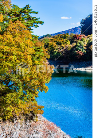 Lake Okutama in Tokyo is ablaze with autumn colors. Lake Okutama in Tokyo is ablaze with autumn colors. 140818615