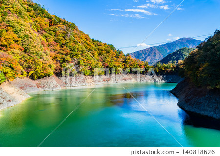 Lake Okutama in Tokyo is ablaze with autumn colors. Lake Okutama in Tokyo is ablaze with autumn colors. 140818626