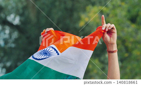 People celebrating India Day in Moscow, holding Indian flag and showing symbol of unity People celebrating India Day in Moscow, holding Indian flag and showing symbol of unity 140818661