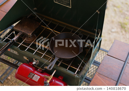A skillet placed on a two-burner stove. 140818670