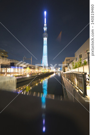 The illuminated Tokyo Skytree as seen directly in front from the riverside in Tokyo Mizumachi. The illuminated Tokyo Skytree as seen directly in front from the riverside in Tokyo Mizumachi. 140819460