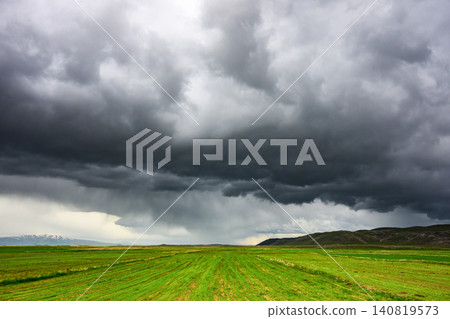 Dramatic sky with heavy rain falling over green grasslands Dramatic sky with heavy rain falling over green grasslands 140819573