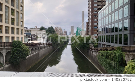 The calm surface of the Meguro River and the Tokyo cityscape The calm surface of the Meguro River and the Tokyo cityscape 140820792