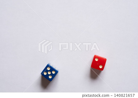 Blue and red dice on a white background Blue and red dice on a white background 140821657