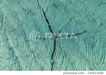 Closeup of green painted tree stump showing natural wood grain cracks weathered texture creating rustic abstract background for design decorative projects Closeup of green painted tree stump showing natural wood grain cracks weathered texture creating rustic abstract background for design decorative projects 140822086
