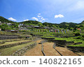 A scene of terraced rice paddies in fallow fields in early summer, with carp streamers flying. 140822165
