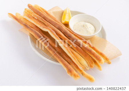 A plate of homemade grissini and cream cheese dip (12 servings) A plate of homemade grissini and cream cheese dip (12 servings) 140822437