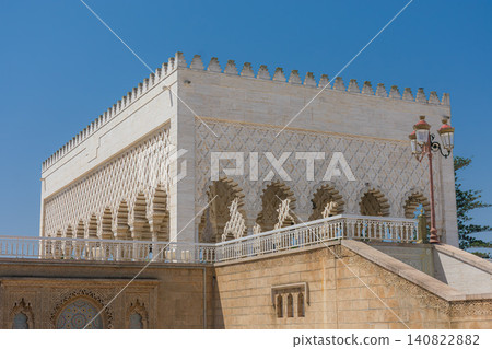 The Mausoleum of Mohammed V displays its carved white stone facade under the blue sky of Rabat, Morocco. The Mausoleum of Mohammed V displays its carved white stone facade under the blue sky of Rabat, Morocco. 140822882
