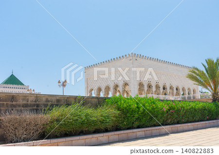 The Mausoleum of Mohammed V displays its carved white stone facade under the blue sky of Rabat, Morocco. The Mausoleum of Mohammed V displays its carved white stone facade under the blue sky of Rabat, Morocco. 140822883