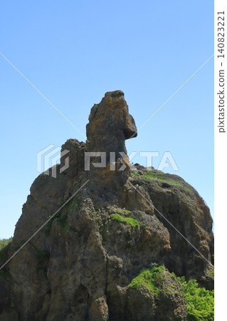 The imposing presence of Godzilla Rock in Utoro, soaring towards the blue sky. The imposing presence of Godzilla Rock in Utoro, soaring towards the blue sky. 140823221