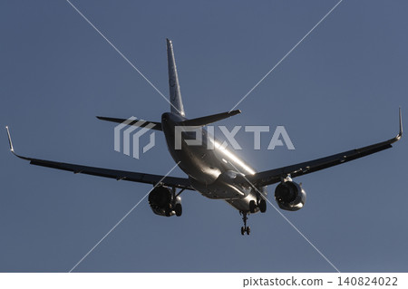 Airplane shining in the backlight 140824022