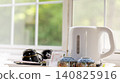 A teapot placed on the windowsill 140825916