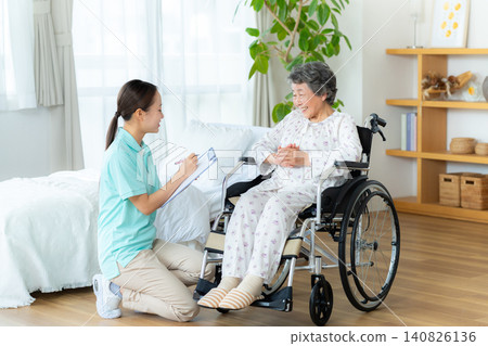 Senior woman living in a nursing home and a young helper Senior woman living in a nursing home and a young helper 140826136