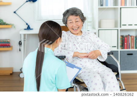 Senior woman living in a nursing home and a young helper Senior woman living in a nursing home and a young helper 140826162