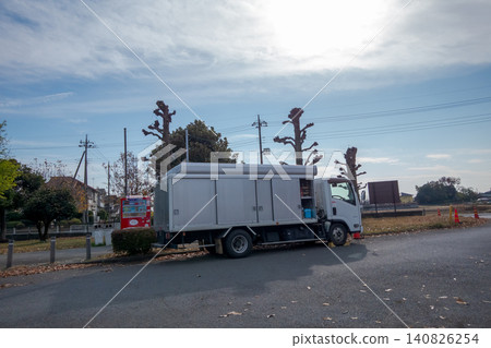 A beverage replenishment route car parked in front of a vending machine. A beverage replenishment route car parked in front of a vending machine. 140826254