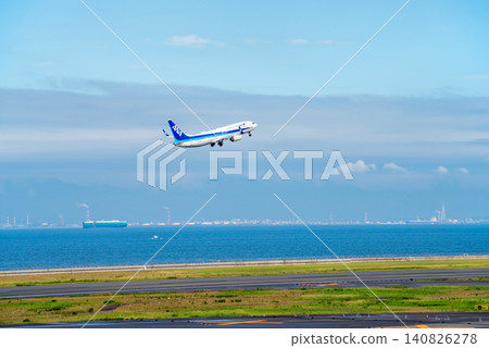 A passenger plane takes off from Chubu Centrair International Airport with Ise Bay and the Yokkaichi industrial complex in the background. A passenger plane takes off from Chubu Centrair International Airport with Ise Bay and the Yokkaichi industrial complex in the background. 140826278