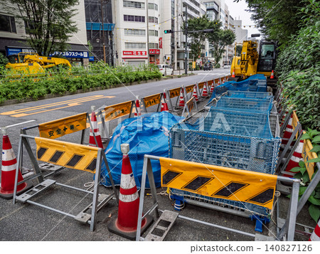 Temporary fences and construction machinery at a road construction site Temporary fences and construction machinery at a road construction site 140827126