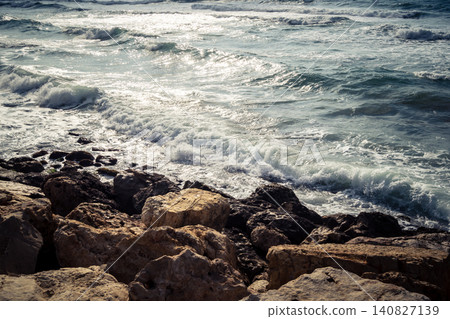 Waves crashing against the rocky coastline with a view of the Mediterranean Sea in Tel Aviv Waves crashing against the rocky coastline with a view of the Mediterranean Sea in Tel Aviv 140827139