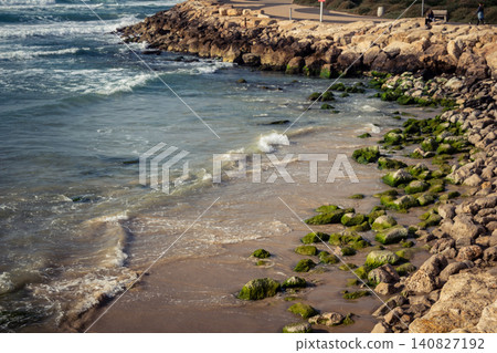 Waves crashing against the rocky coastline with a view of the Mediterranean Sea in Tel Aviv Waves crashing against the rocky coastline with a view of the Mediterranean Sea in Tel Aviv 140827192