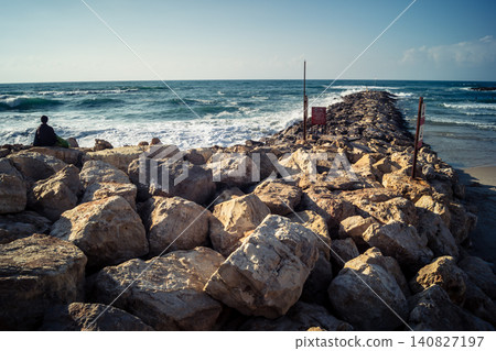 Waves crashing against the rocky coastline with a view of the Mediterranean Sea in Tel Aviv Waves crashing against the rocky coastline with a view of the Mediterranean Sea in Tel Aviv 140827197