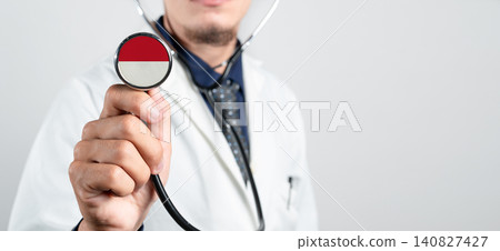 Monaco healthcare system, Monegasque national healthcare concept. Hand of doctor holding stethoscope Monaco healthcare system, Monegasque national healthcare concept. Hand of doctor holding stethoscope 140827427