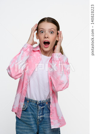 Shocked teenage girl with surprised facial expression Shocked teenage girl with surprised facial expression 140828223